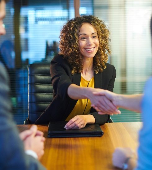 Black woman shaking hands of interviewer