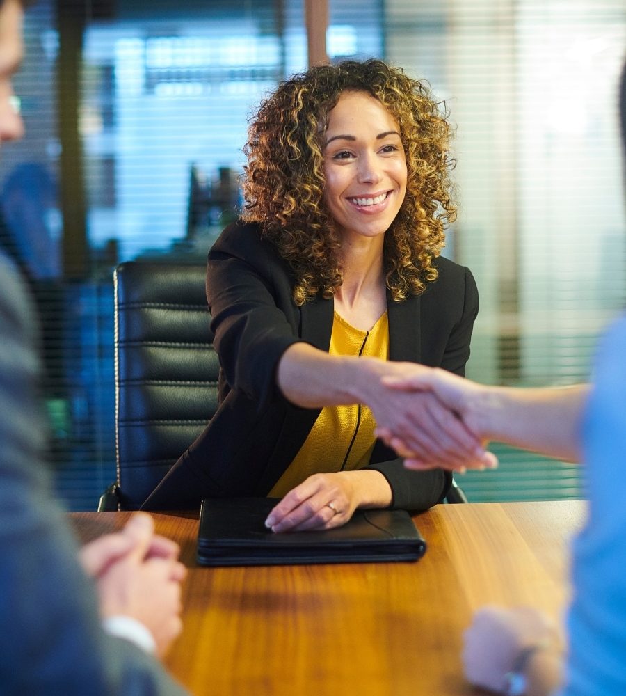 Black woman shaking hands of interviewer