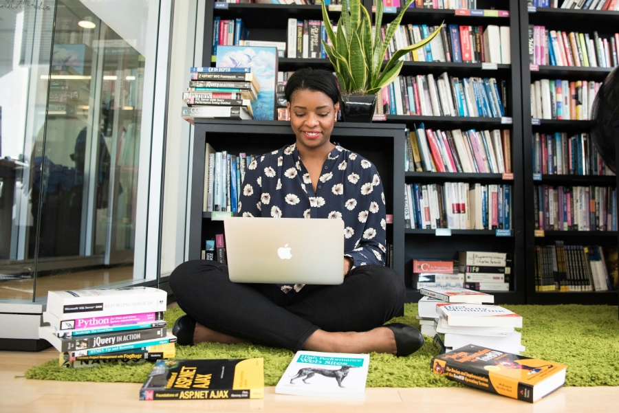 Passion Projects - Woman learning to code with books