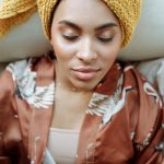 Black women relaxing in a bathrobe and turban for self care