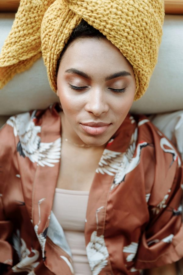 Black women relaxing in a bathrobe and turban for self care